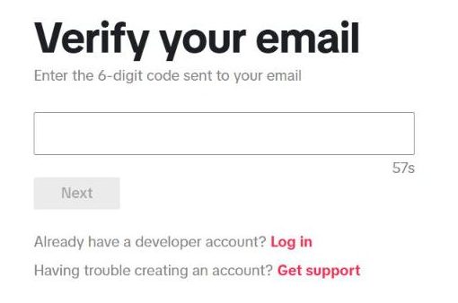 Halaman "Verify your email" di TikTok for Developers: kalimat "Enter the 6-digit code sent to your email", kolom kode dengan hitung mundur, tombol Next, serta tautan "Already have a developer account? Log in" dan "Having trouble creating an account? Get support".