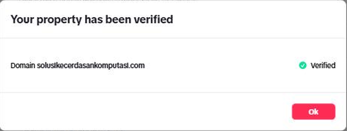 Jendela "Your property has been verified": baris "Domain solusikecerdasankomputasi.com" bertanda hijau "Verified" dan tombol merah Ok.